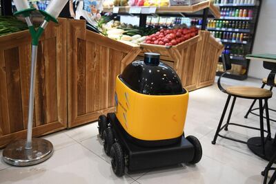 In this photo taken on June 28, 2018, a Zhen Robotics delivery robot is seen in a Suning supermarket during a demonstration of the robot in Beijing. Along a quiet residential street on the outer edges of Beijing, a yellow and black cube about the size of a small washing machine trundles leisurely to its destination. This "little yellow horse" is an autonomous delivery robot, ferrying daily essentials like drinks, fruit and snacks from the local store to the residents of the "Kafka" compound in the Chinese capital.
 - TO GO WITH AFP STORY CHINA-TECHNOLOGY-ROBOTS-CONSUMER-SCIENCE,FEATURE BY LUDOVIC EHRET
 / AFP / GREG BAKER / TO GO WITH AFP STORY CHINA-TECHNOLOGY-ROBOTS-CONSUMER-SCIENCE,FEATURE BY LUDOVIC EHRET
