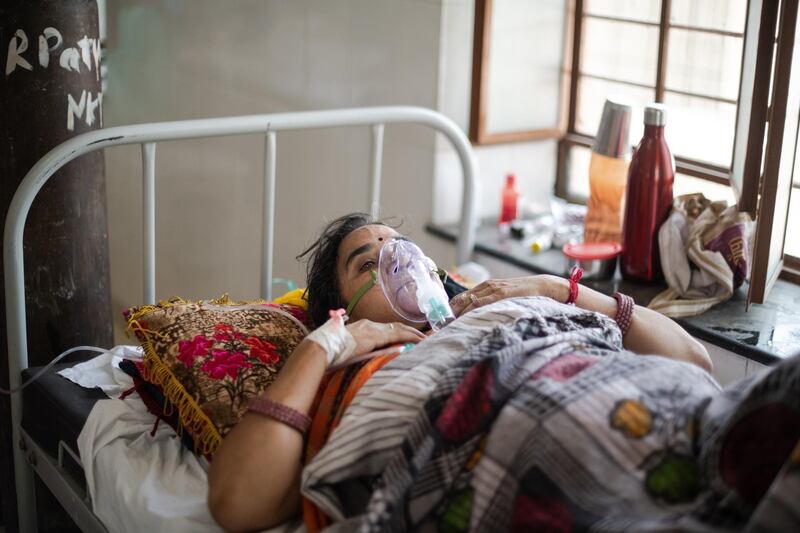 Misri Devi, 55, receives supplemental oxygen during treatment for the coronavirus at the Kapil Government Hospital, in Neem Ka Thana, Sikar District, Rajasthan, India. Getty