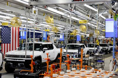 GM's electric Hummer on the production line. The car maker's chief executive has said its labour costs are already $22 an hour more than electric-vehicle leader Tesla. Reuters