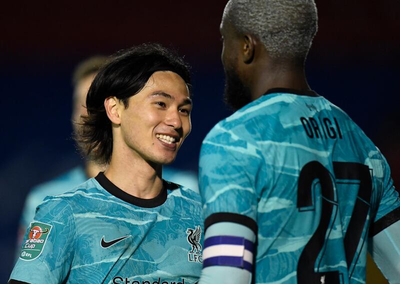 Liverpool's Divock Origi celebrates with teammate Takumi Minamino. EPA