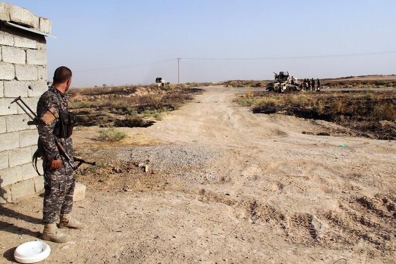 Residents, security forces and volunteer militia fighters hold a position in the town of Amerli on August 4, 2014. The Turkmen Shiite town has been surrounded by Sunni militants of the Islamic State group for more than six weeks. Ali Al Bayati / AFP