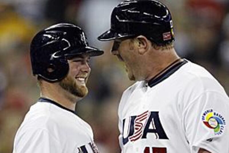 Adam Dunn, right, celebrates his two-run homer with his teammate Brian McCann in the eighth innings of the USA's World Baseball Classic opener against Canada.