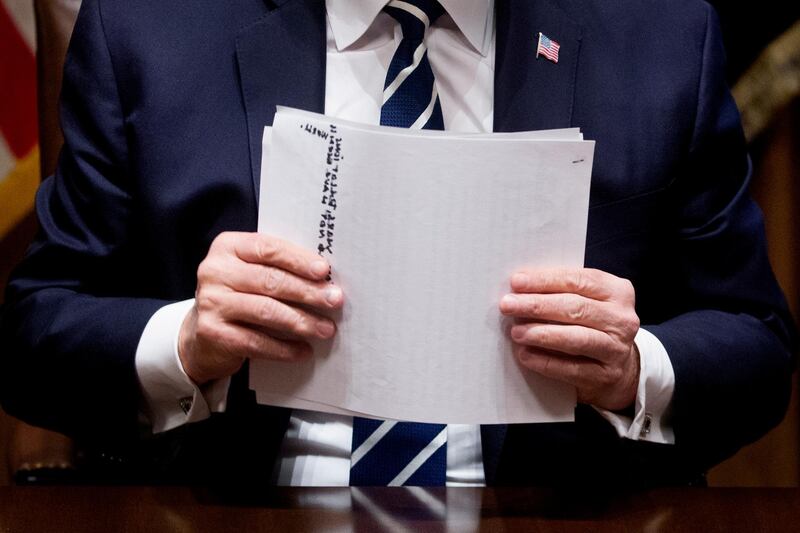 Donald Trump holds his notes after delivering remarks to members of the media. EPA