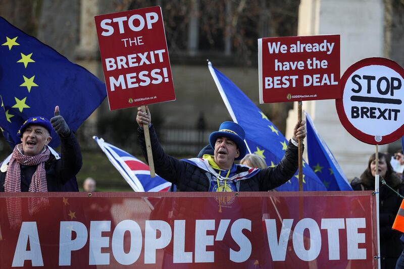 Anti-Brexit protesters hold signs outside the Houses of Parliament  in London, Britain January 11, 2019. REUTERS/Simon Dawson