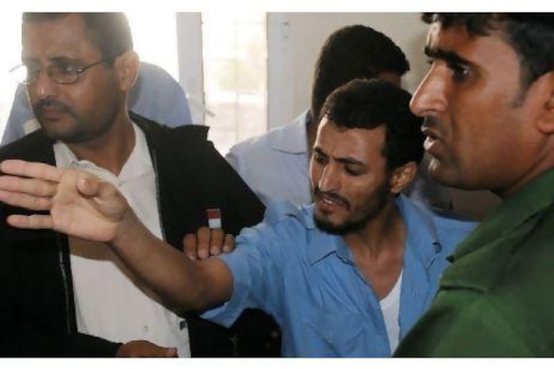 Yemeni Fares Abdullah Saleh (C) gestures as he is sentenced to death at a special criminal court in the southern Yemeni city of Aden on December 11, 2010. Saleh is convicted of bombings that reportedly killed at least three people at a sports club in Aden. AFP PHOTO/STR
 *** Local Caption *** 855536-01-08.jpg