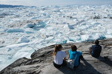 Visitors look out onto free-floating ice jammed into the Ilulissat Icefjord during unseasonably warm weather on July 30, 2019 near Ilulissat, Greenland. Climate change is having a profound effect in Greenland, where over the last several decades summers have become longer and the rate that glaciers and the Greenland ice cap are retreating has accelerated. Getty