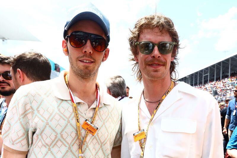 Musicians Evan Westfall and Taylor Meier pose for a photo on the grid prior to the F1 Grand Prix of Miami. AFP

