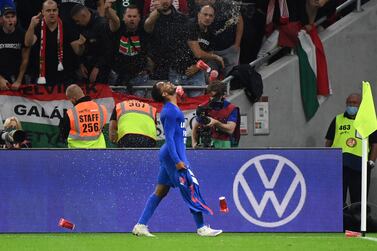 Hungary's fans react throwing cups of beer at England's forward Raheem Sterling as he celebrates scoring the opening goal during the FIFA World Cup Qatar 2022 qualification Group I football match between Hungary and England, at the Puskas Arena in Budapest on September 2, 2021.  (Photo by ATTILA KISBENEDEK  /  AFP)