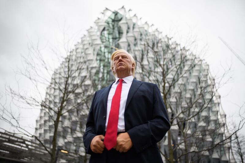 LONDON, ENGLAND - JANUARY 12:  A model of US President Donald Trump from the Madame Tussaud's waxwork attraction is seen outside the new US embassy on January 12, 2018 in London, England.  President Trump has tweeted that he will not go ahead with his planned visit to the new billion-dollar embassy, blaming previous President Barack Obama's "bad" embassy deal as his reason for cancelling. Critics have speculated that Mr Trump could have been wary of protests and demonstrations if he chose to go ahead with his February visit.  (Photo by Leon Neal/Getty Images)