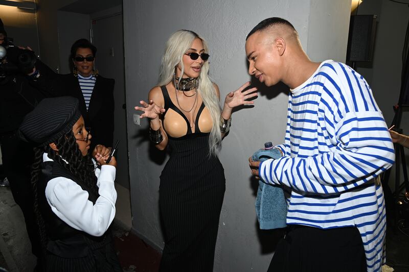 North West, left, Kim Kardashian, centre, and designer Olivier Rousteing are seen backstage after the Jean Paul Gaultier show. Getty