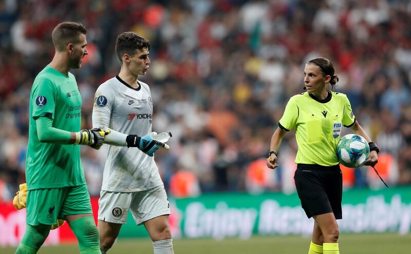 Stephanie Frappart with Chelsea's Kepa Arrizabalaga and Liverpool's Adrian before the penalty shootout. Reuters