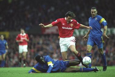 31 Oct 1992: Robbie Earle of Wimbledon slides in to tackle Darren Ferguson of Manchester United during an FA Carling Premier League match at Old Trafford in Manchester, England. Wimbledon won the match 1-0. \ Mandatory Credit: Gary M Prior/Allsport