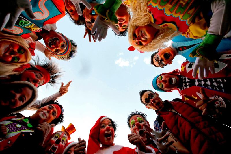 Clowns surround the camera. AFP