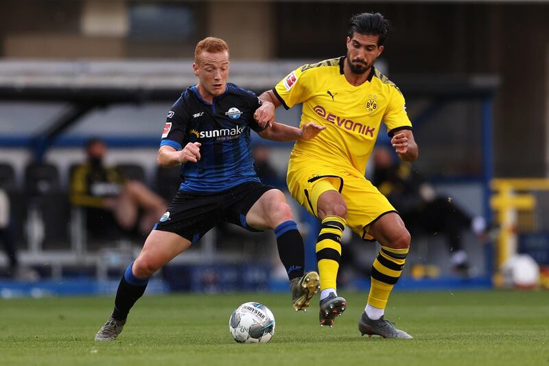 Sebastian Vasiliadis, left, of SC Paderborn battles for the ball with Emre Can of Borussia Dortmund. EPA