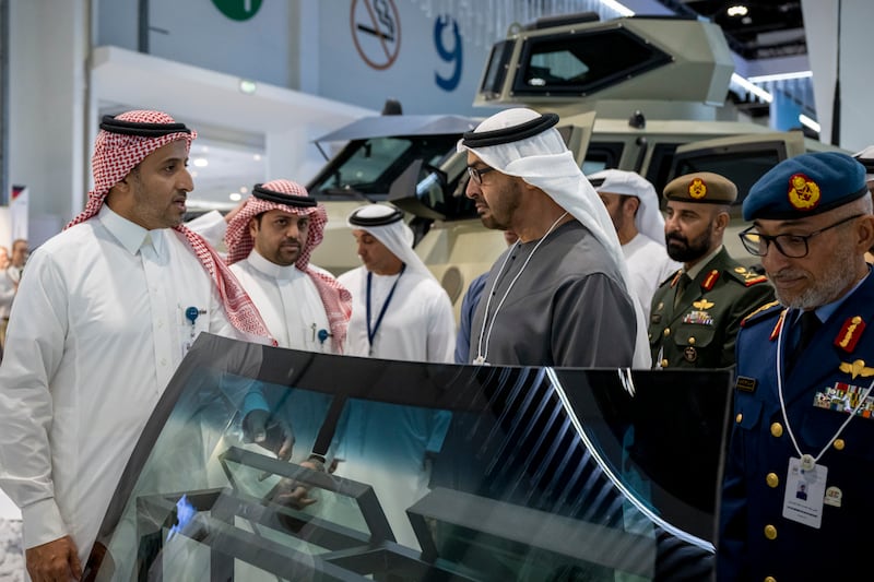 The President and Lt Gen Al Mazrouei, right, visit a booth at the event