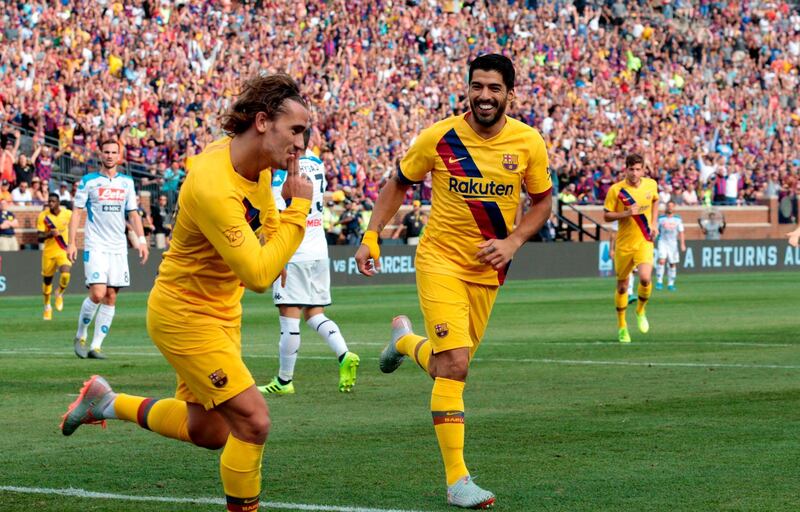 Griezmann celebrates with Luis Suarez. AFP