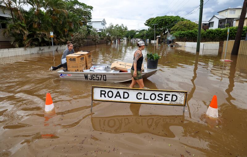 People use a boat to save items from their home in Auchenflower in Brisbane, Australia. From Brisbane in Queensland to Lismore in northern New South Wales, flood-affected communities are cleaning up debris as the weather system moves south towards Sydney. Getty Images