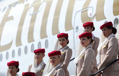 Cabin crew are seen on the steps leading to an Emirates A380 airplane, the world's largest passenger aircraft, at Manchester Airport after it's arrival on a flight from Dubai, Manchester, England, Wednesday September 1, 2010. When the CAA Aerodrome Standards Division gave their a approval, the airport joined a select group of only 17 global airports to be certified meaning Manchester becomes the first regional airport in the World to have a regular service by an A380. Manchester Airport has invested more than £10 million upgrading the airfield to the standards needed for the Emirates super-jumbo. This includes reconstructing a new aircraft stand with state of the art equipment including an advance docking system, which guides the pilot onto the stand and into the correct position for the unique double airbridge to connect. Construction has taken place over the last 18 months on the airfield at Manchester. (AP Photo/Jon Super).  
