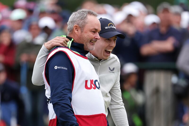 Matt Fitzpatrick of England celebrates winning on the 18th green with caddie Billy Foster. AFP

