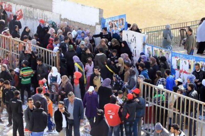 Jordanians queue outside a polling station in the Palestinian refugee camp of Baqaa, north of Amman.