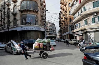 An ambulant vendor pulls his handcart in the Lebanese coastal city of Tripoli, north of Beirut. Lebanon's economy continued to deteriorate in January amid a surge in Covid-19 infections. AFP