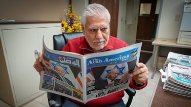 Osama Siblani reads a copy of The Arab American News. Joshua Longmore / The National