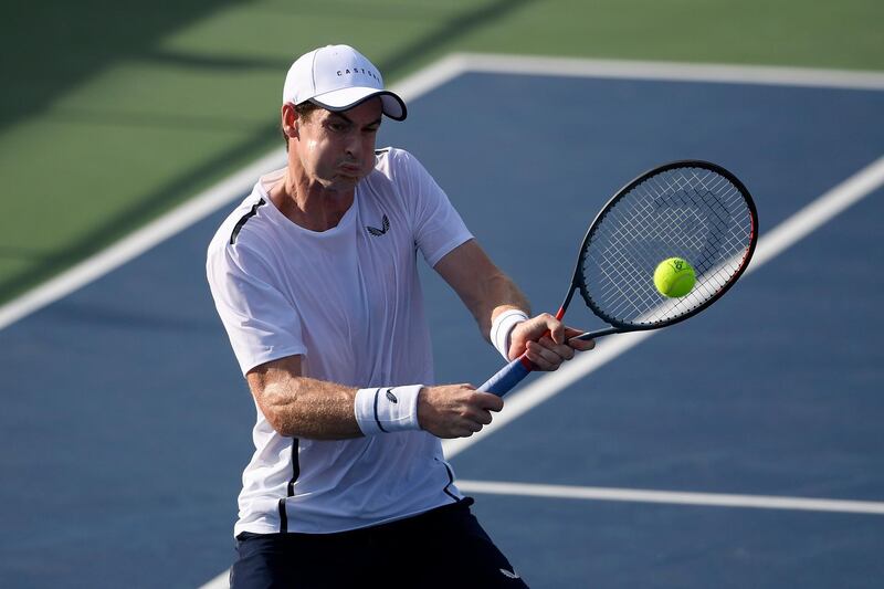 Andy Murray returns the ball as he and Jamie Murray, both of Britain, played a doubles match in the Citi Open tennis tournament against Raven Klaasen, of South Africa, and Michael Venus, of New Zealand, Friday, Aug. 2, 2019, in Washington. (AP Photo/Nick Wass)