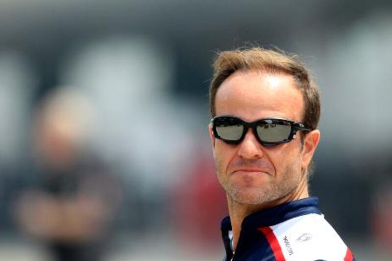 Williams Formula One driver Rubens Barrichello of Brazil arrives at the Shanghai International Circuit in Shanghai, China, Thursday, April 14, 2011 for the Chinese Formula One Grand Prix. (AP Photo/Eugene Hoshiko) *** Local Caption ***  XEH112_China_F1_GP_Auto_Racing.jpg