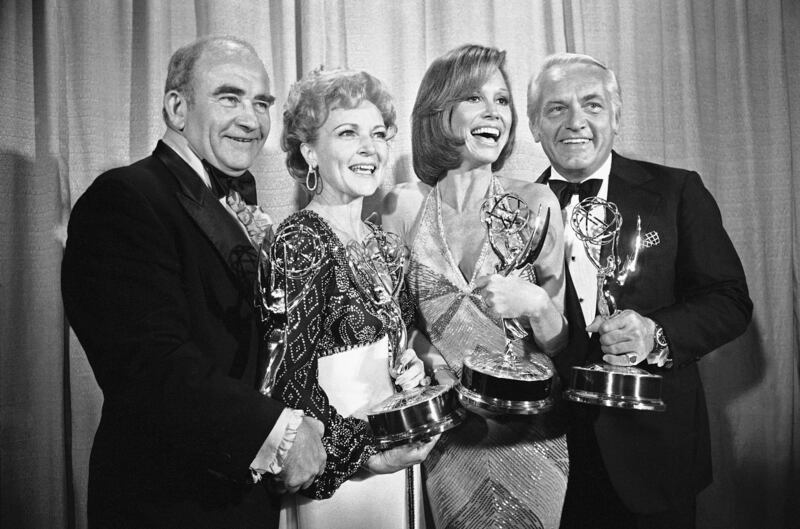 Betty White, in a black sequinned top, with 'Mary Tyler Moore Show' co-stars Ed Asner, Mary Tyler Moore and Ted Knight at the 28th annual Emmy Awards in Los Angeles on May 18, 1976. AP