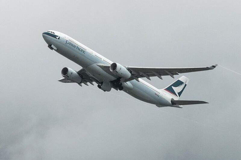 A Cathay Pacific passenger plane takes off from the international airport in Hong Kong. Cathay said first-half profit dropped 82 perc ent from a year earlier, as a Chinese economic slowdown weighs in and the airline faces increasing competition from peers. Anthony Wallace / AFP

