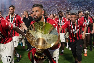 Olivier Giroud celebrates with the Serie A trophy after scoring twice in the 3-0 win over Sassuolo. AP