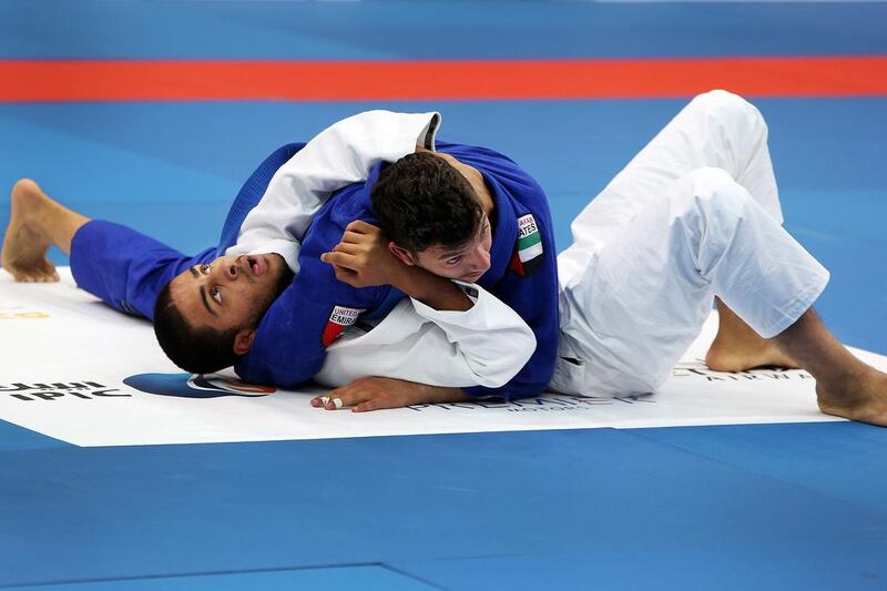 Abdulrahman Albarguthi (top) pins his opponent, Sultan Al Ktebi, in their match. Delores Johnson / The National