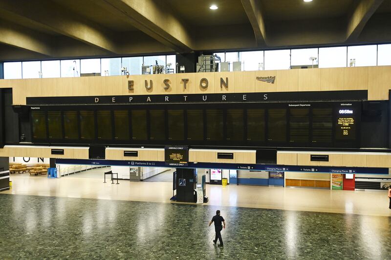 A staff member at the closed Euston Station in London. Rail services in the UK are being disrupted as 9,000 train drivers in the Aslef union strike in a row over pay and conditions. EPA