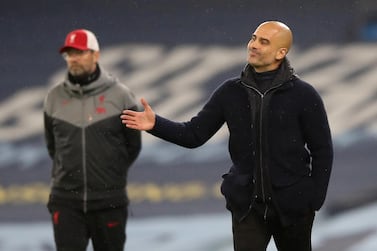 Manchester City manager Pep Guardiola, right, and Liverpool manager Jurgen Klopp. Reuters