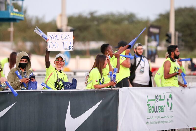 Supporters cheer on the runners at the Abu Dhabi Marathon.