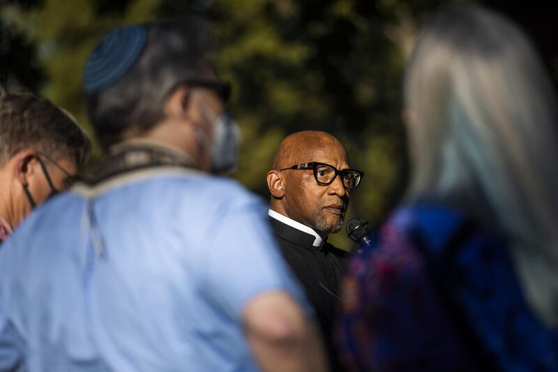 Rev Ray Montgomery of People Acting in Community Together speaks during a vigil held by the Interfaith Community after the shooting. AFP