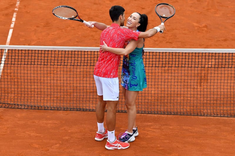 Novak Djokovic hugs Jelena Jankovic during a tennis doubles against Serbia's Nenad Zimonjic and Olga Danilovic at a charity exhibition hosted by Novak Djokovic, in Belgrade. AFP