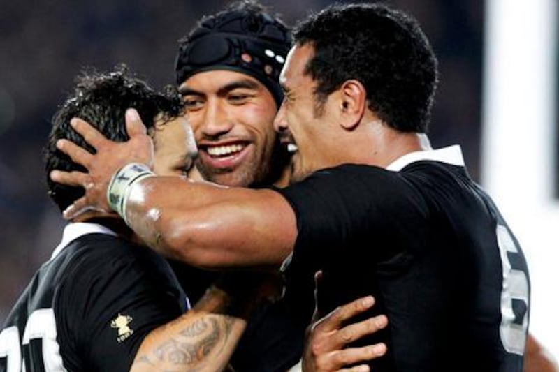 New Zealand All Blacks' Piri Weepu (L) and Victor Vito congratulates Jerome Kaino (R) after Kaino scored a try during their Rugby World Cup Pool A match against Tonga at Eden Park in Auckland September 9, 2011. REUTERS/Nigel Marple (NEW ZEALAND  - Tags: SPORT RUGBY)  