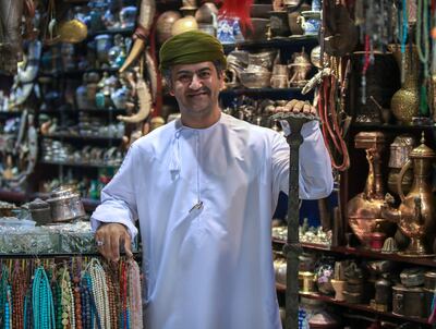Jamal Muhammad Ali Al Balooshi, a shop owner at Mutrah Souq, says business is picking up. Victor Besa / The National