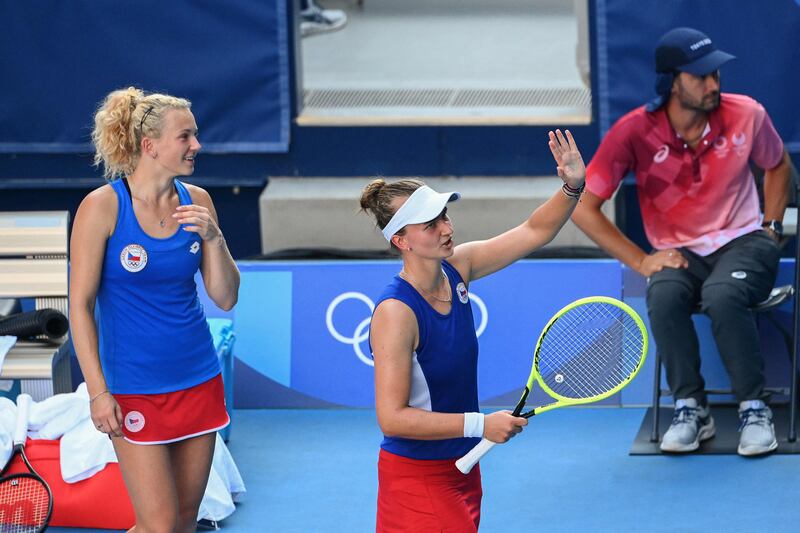 Czech Republic's Barbora Krejcikova (C) and Katerina Siniakova celebrate winning the women's doubles.