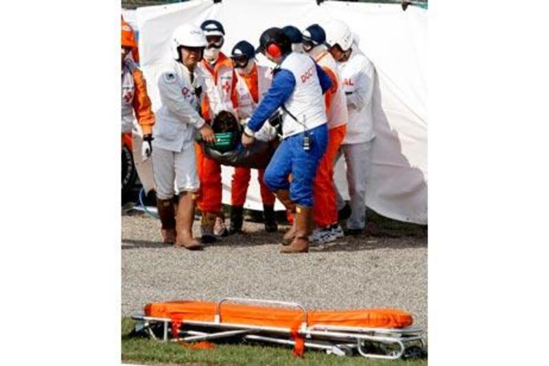 Timo Glock, the German Toyota F1 driver, is carried by rescue staff to an ambulance after crashing during qualifying for the Japanese Grand Prix in Suzuka this month.