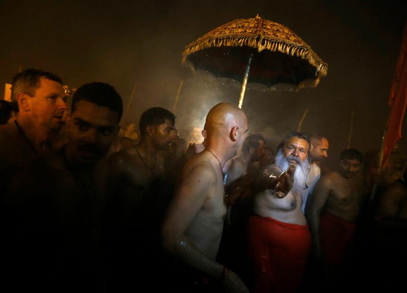 Hindu devotees arrive to attend the first "Shahi Snan" (grand bath) at the ongoing "Kumbh Mela", or Pitcher Festival, in the northern Indian city of Allahabad January 14, 2013. Upwards of a million elated Hindu holy men and pilgrims took a bracing plunge in India's sacred Ganges river to wash away lifetimes of sins on Monday, in a raucous start to an ever-growing religious gathering that is already the world's largest.  REUTERS/Jitendra Prakash (INDIA - Tags: RELIGION SOCIETY) *** Local Caption ***  DEL19_INDIA-FESTIVA_0114_11.JPG