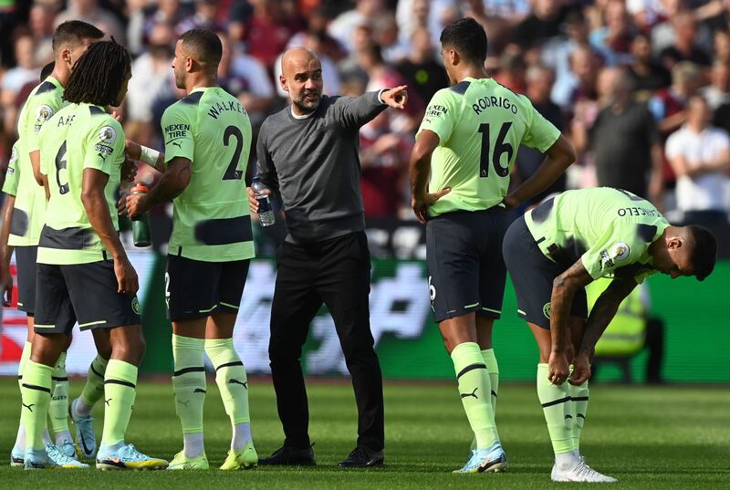 Pep Guardiola gives instructions to his players during a break. EPA