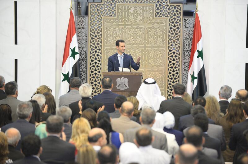 Syrian president Bashar Assad delivering a speech during a meeting with heads and members of public organizations, vocational syndicates, and chambers of industry, trade, agriculture and tourism in Damascus. Sana Handout / EPA