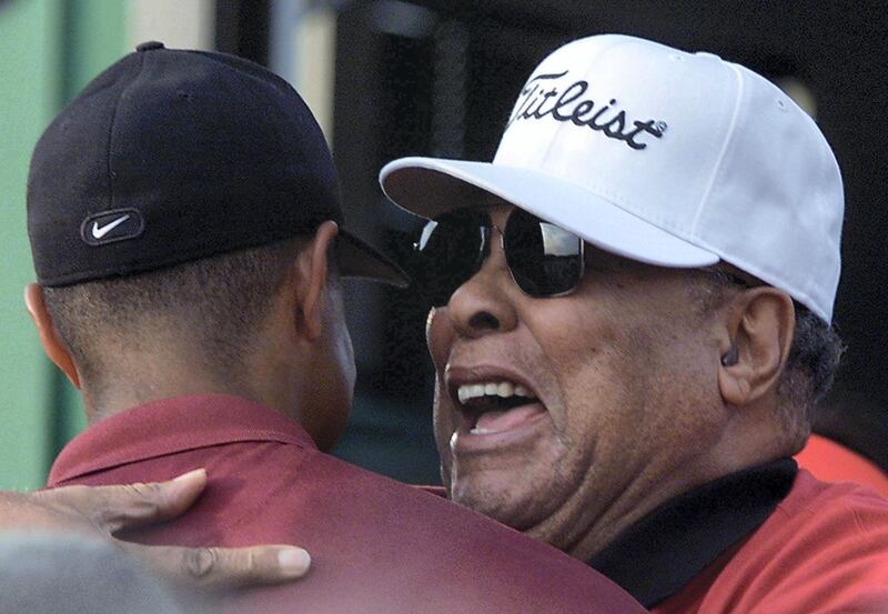 Tiger Woods of the US (L) is hugged by his father Earl (R) after winning the 2001 Masters golf tournament at the Augusta National Golf Club08 April 2001 in Augusta, Georgia.  Woods held his nerve in one of the most thrilling final days in Masters history to become the first player ever to hold all four Major titles at the same time. AFP PHOTO/Robert SULLIVAN (Photo by ROBERT SULLIVAN / AFP)