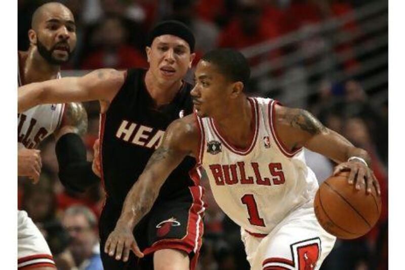 Mike Bibby, right, of Chicago, tries to find a way past the Miami defence during Game 1 of their Eastern Conference play-off final on Sunday night. The Bulls beat the Heat 103-82.