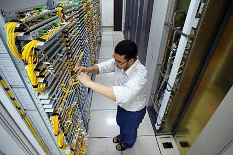 18/07/10 - Abu Dhabi, UAE -   An Etisalat employee works on a company order for high speed fiber optic internet service in the basement at the headquarters of Etisalat.  Etisalat is an UAE-based telecommunications services provider, currently operating in 18 countries across Asia, the Middle East and Africa.  Etisalat is the 13th largest mobile network operator in the world, with a total customer base of 100 million.  It provides mobile, landline, internet and television services.  (Andrew Henderson/The National)