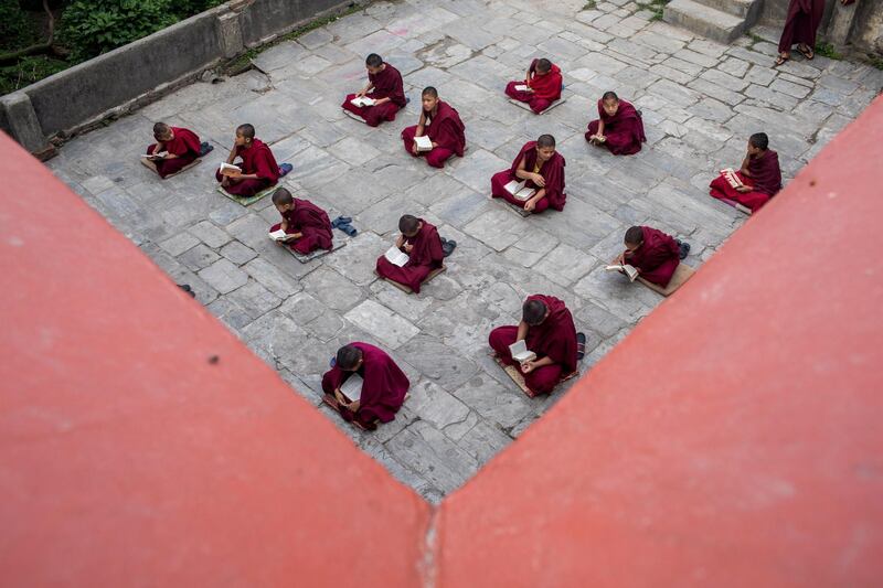 Nepalese Buddhist monks attend their class, respecting social distancing, at a monastery in Kathmandu, Nepal.  EPA