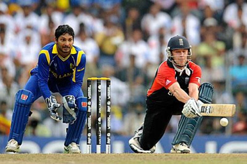 England's Jonathan Trott plays a reverse sweep as Sri Lanka's captain and wicketkeeper Kumar Sangakkara looks on. Philip Brown / Reuters