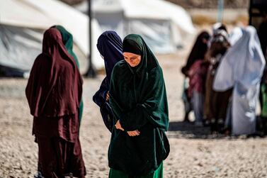 Women walk at Camp Roj, which houses family members of people accused of belonging to ISIS, in Syria's north-eastern Hassakeh province on September 30, 2020. AFP